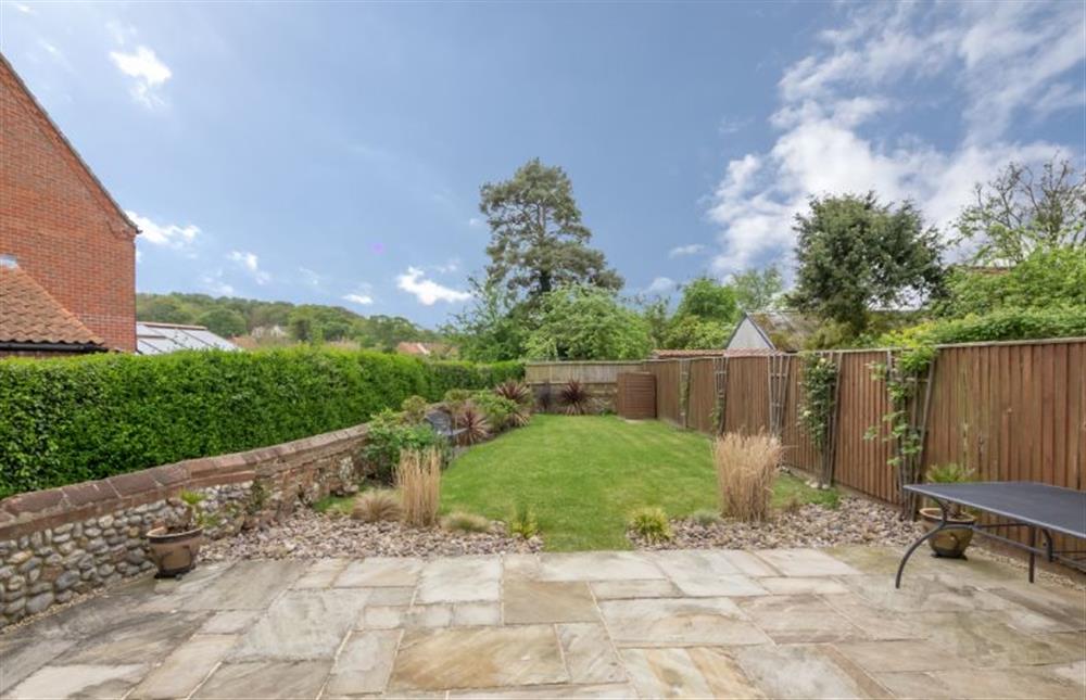 The garden is laid to patio and lawn at Skimming Stones, North Creake near Fakenham