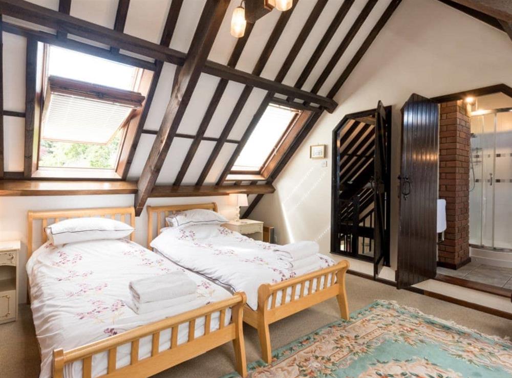 Beamed twin bedroom with sloping ceilings at Sky Lark in Weybourne, Norfolk., Great Britain