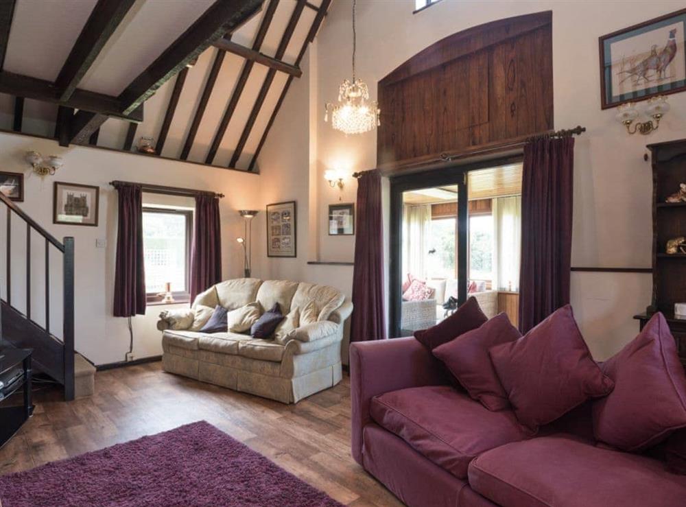 Spacious living room with woodburner at Sky Lark in Weybourne, Norfolk., Great Britain