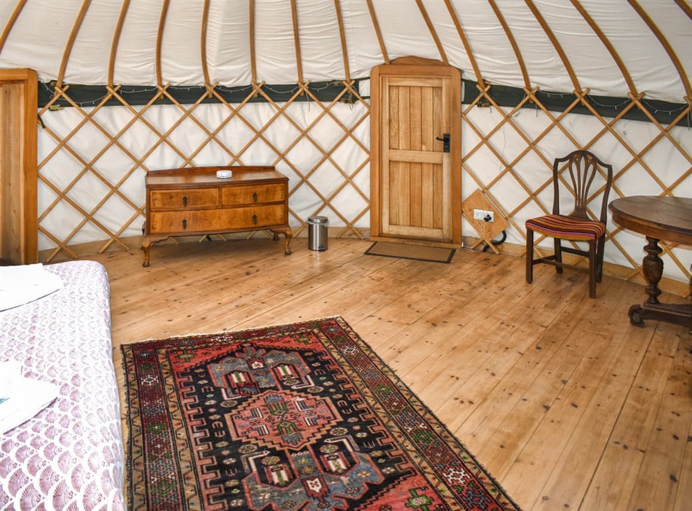 Open plan living space at Skylark Yurt in Beaminster, Dorset