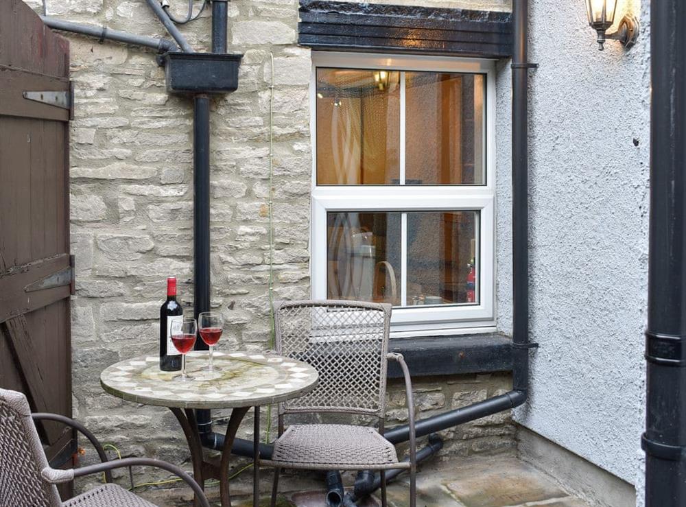 Patio area with outdoor furniture at Slaters Cottage in Middleham, near Leyburn, North Yorkshire