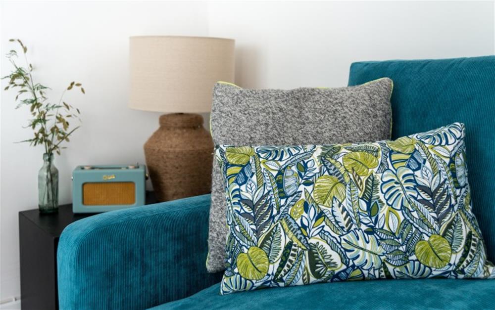 The blue sofa and co-ordinating cushions add a splash of colour.