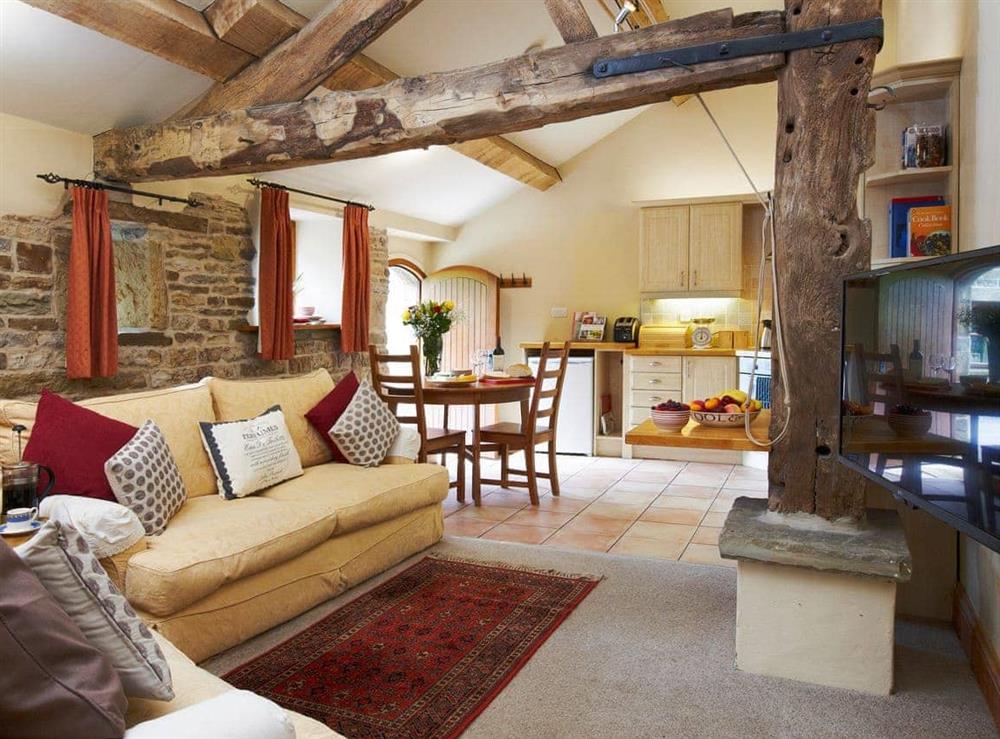 Open plan living space with beams at Bramble Cottage, 