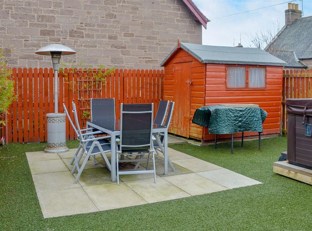 Spacious garden with hot tub/ sitting out area at Smiddy Bothy in Edzell, near Montrose, Angus