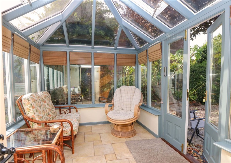 Enjoy a glass of wine on the patio at Smugglers Cottage, Barton On Sea