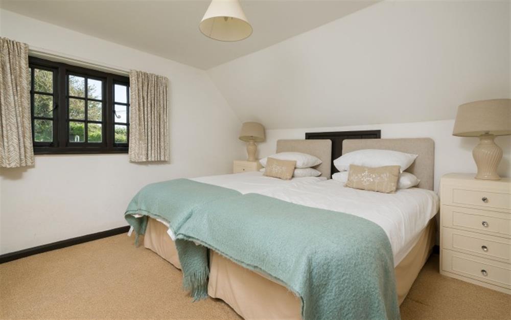 Bedroom 3: The large twin bedroom, overlooking the garden at Smugglers End in Hope Cove