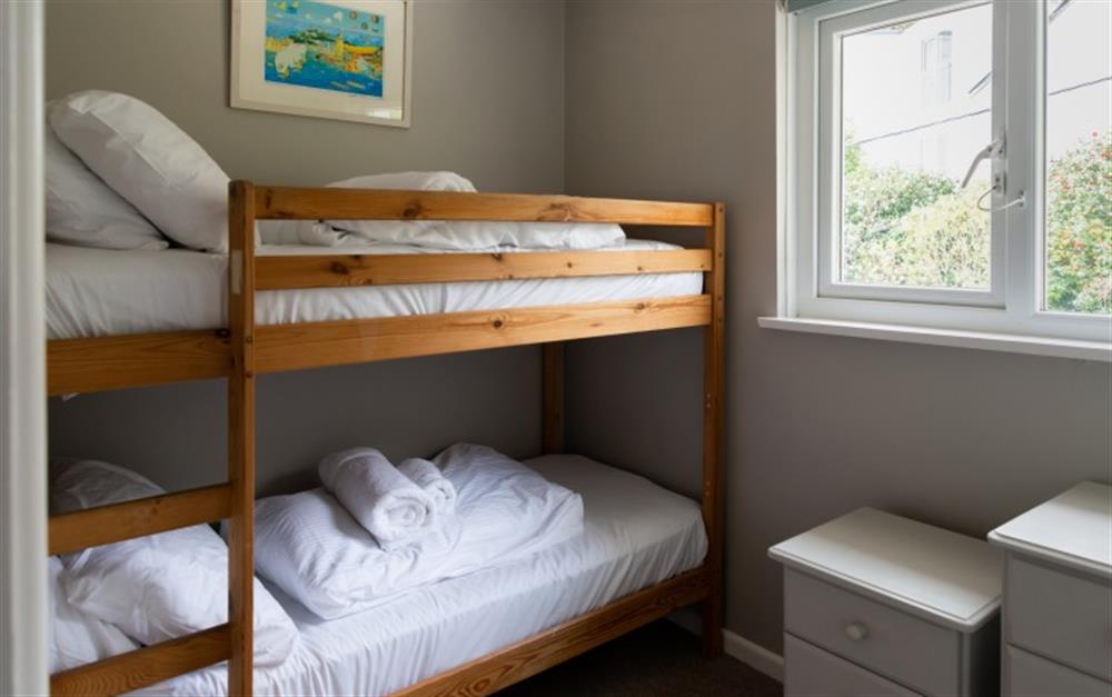 The bunk bedroom, which is the smallest bedroom has lovely pictures of Helford Passage on the walls. at Smugglers in Helford Passage