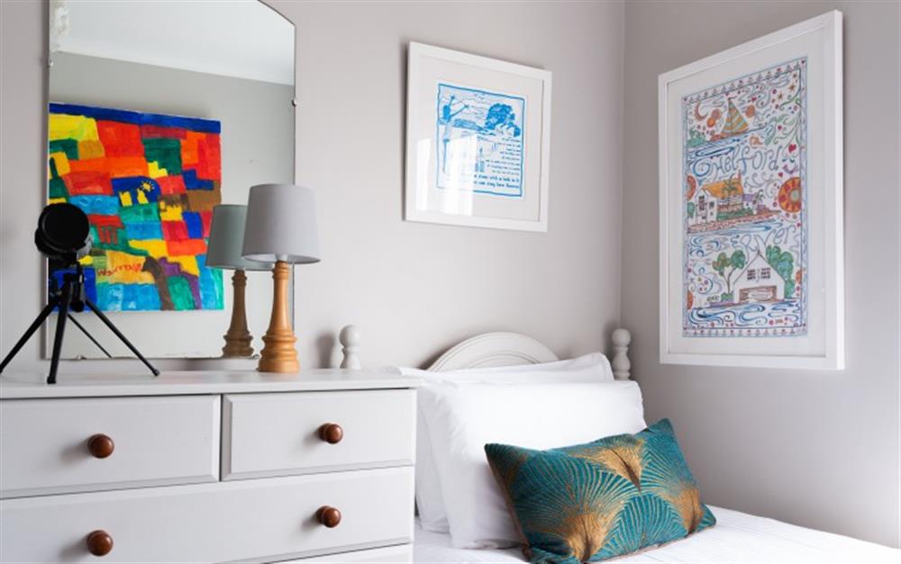 The twin bedroom has great colourful pictures, note the brightly painted print in the reflection in the mirror! at Smugglers in Helford Passage