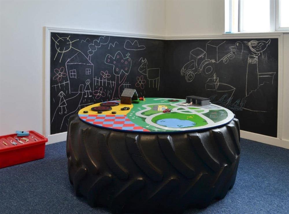 Chalkboard and play area within the games room at Smuggler’s Retreat in Hartland Point, Devon