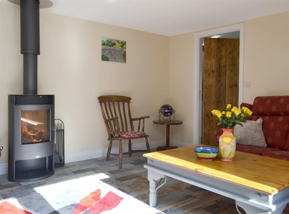 Cosy living area with wood burner at Snipelands Barn in Wedmore, near Glastonbury, Somerset
