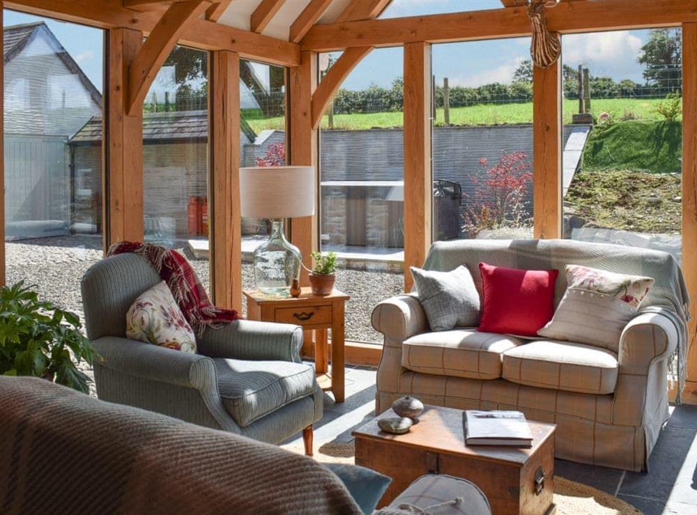 Oak-framed sun room with access to the courtyard area at Soar Cottage in Dihewyd, near Aberaeron, Ceredigion, Dyfed