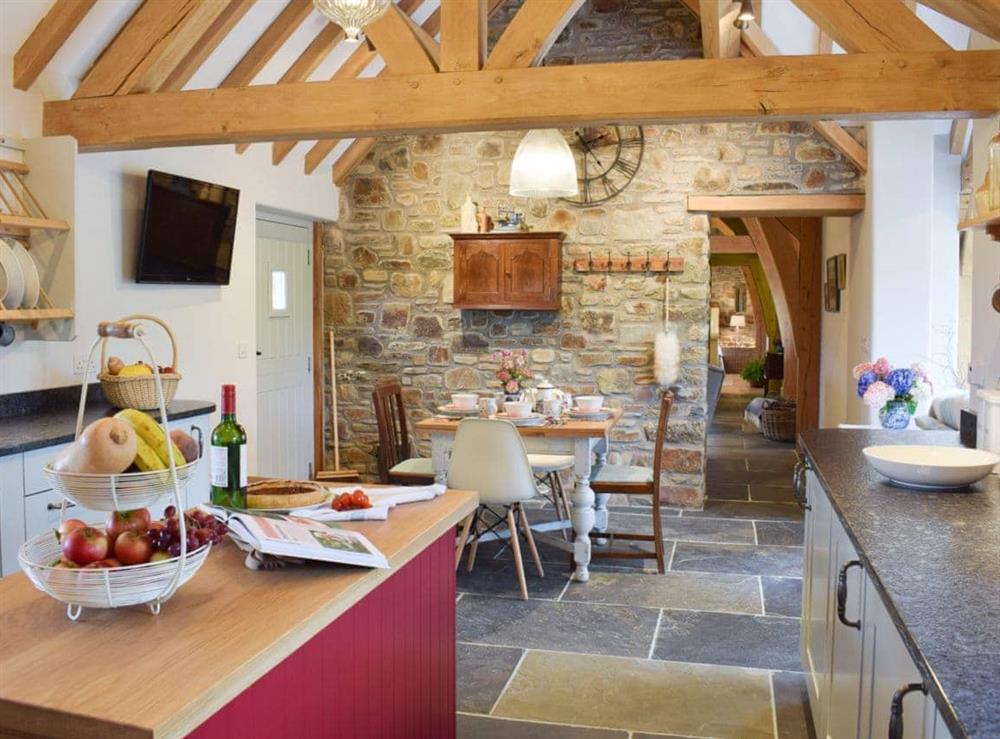 Spacious slate-floored kitchen and dining area at Soar Cottage in Dihewyd, near Aberaeron, Ceredigion, Dyfed