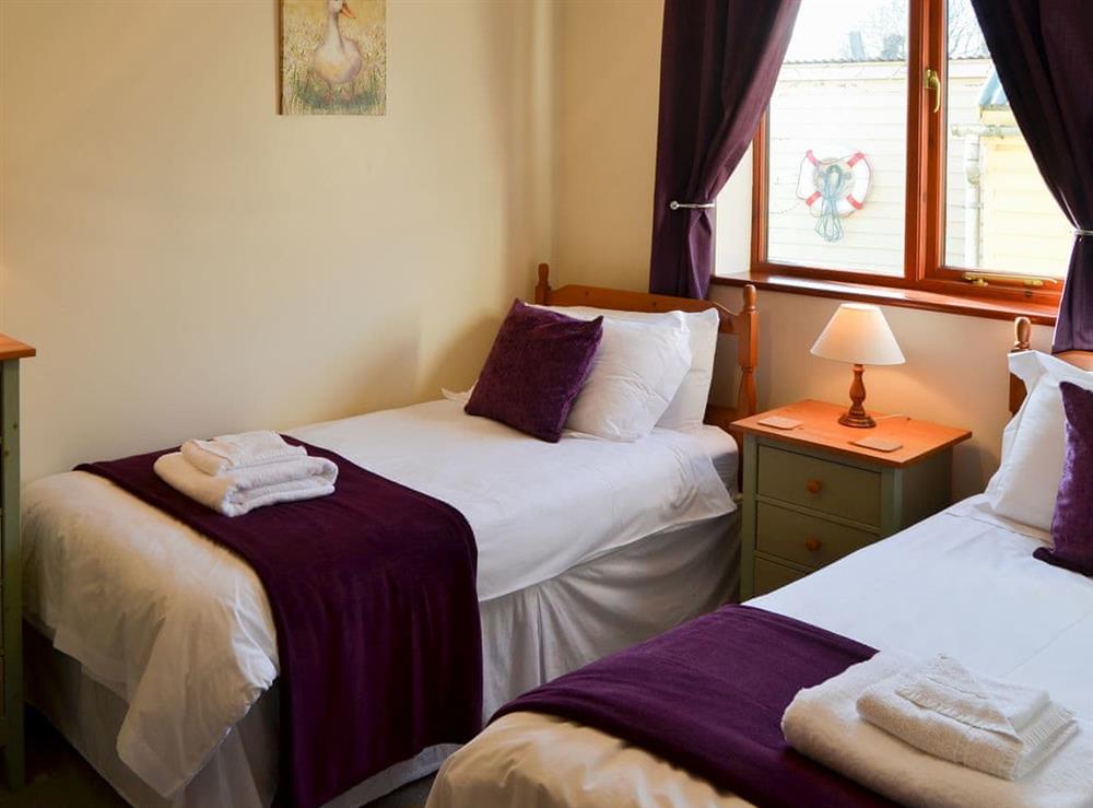 Pretty bedroom with twin single beds at Solace in Stalham Staite, near Sea Palling, Norfolk