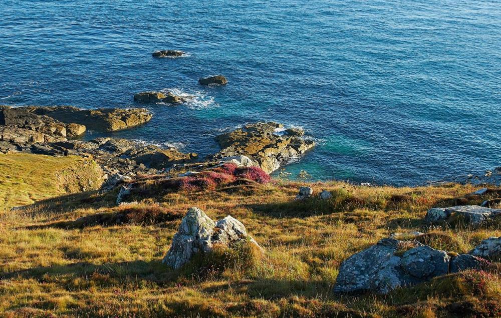 The South West Coast path passes round the headland at Solebay Cottage, Pendeen Lighthouse