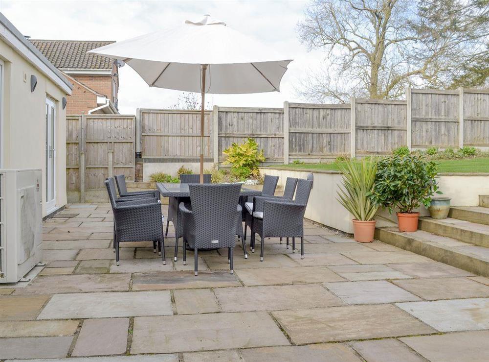 Paved patio with outdoor furniture at Solitaire in South Creake, near Fakenham, Norfolk, England