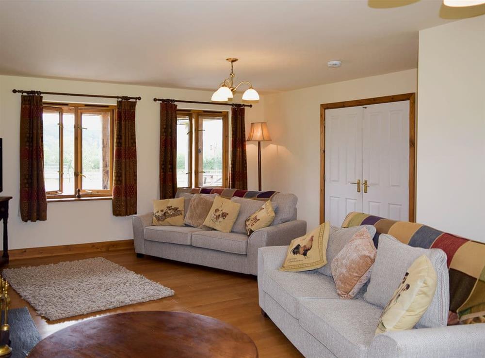 Spacious living room with wood burner (photo 2) at Solitude in Aberhafesp, near Newtown, Powys