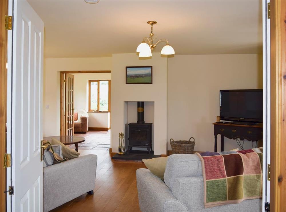 Spacious living room with wood burner (photo 3) at Solitude in Aberhafesp, near Newtown, Powys