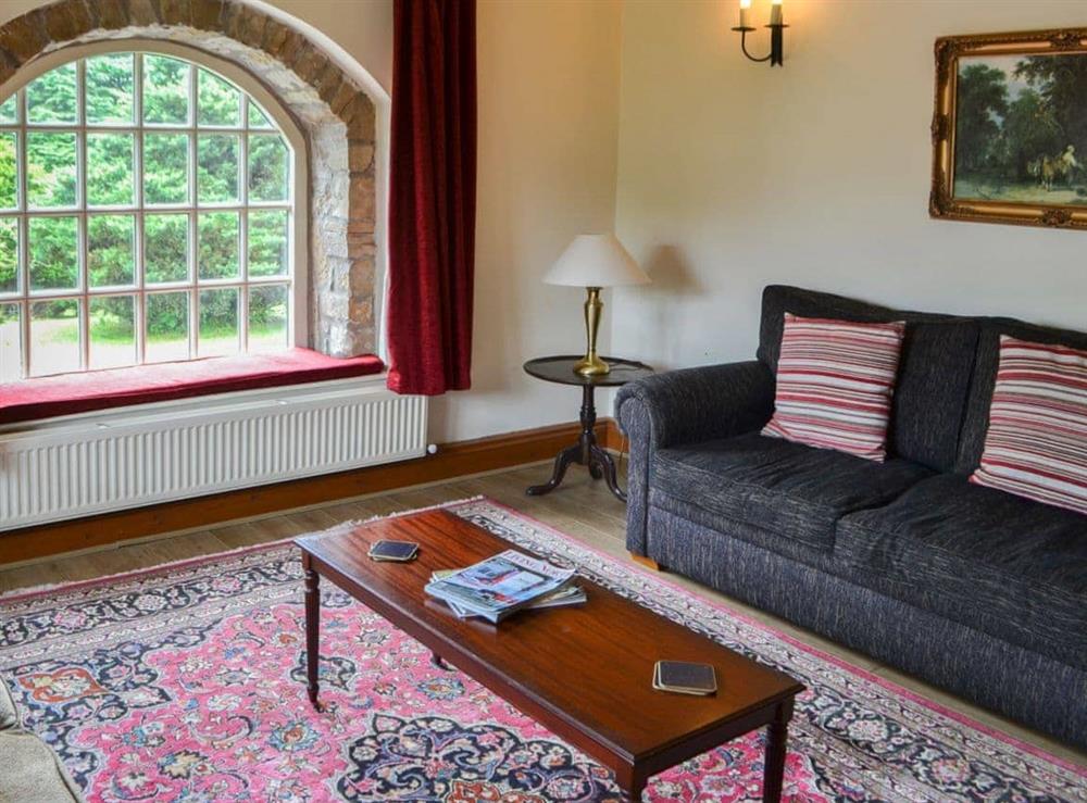 Delightful living room with beautiful windows at Cobweb Cottage, 