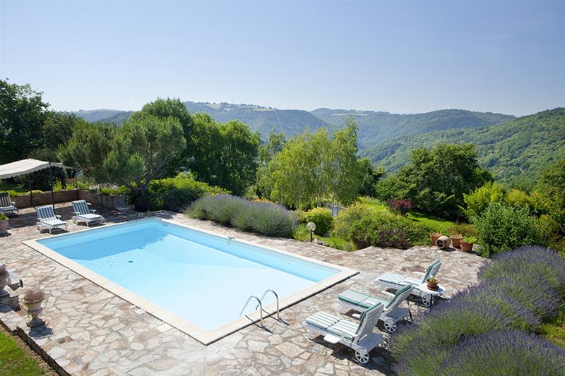 Swimming pool and surrounding countryside at Soulages, Aveyron, France