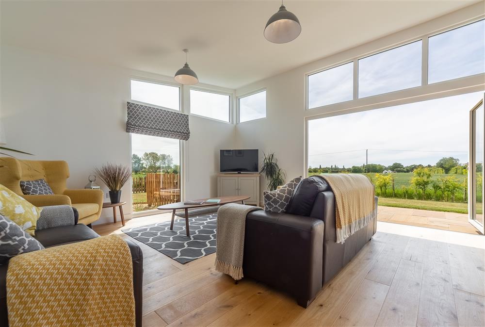 Duel aspect open plan living area with bi folding doors opening out onto the garden at South Barn, Ingham