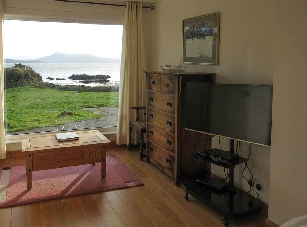View from the ground floor en-suite bedroom with king sized bed at South Bay Cottage in Saasaig, Teangue, Isle of Skye., Great Britain