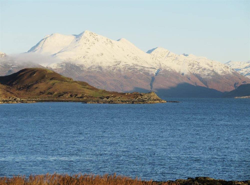 View of the adjacent snow-capped mountains at South Bay Cottage in Saasaig, Teangue, Isle of Skye., Great Britain