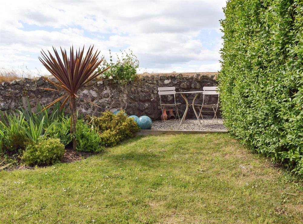 Lawned garden with outdoor seating area at South House in Lathones, near St Andrews, Fife