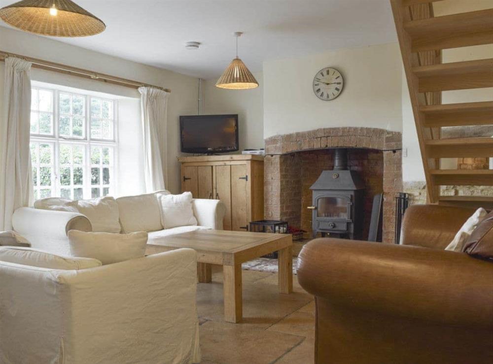 Delightful living area with wood burner at South View Cottage in Dean, near Chadlington, Oxfordshire