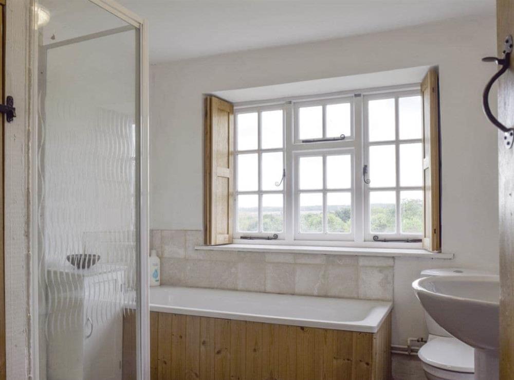 Family bathroom with separate bath and shower cubicle at South View Cottage in Dean, near Chadlington, Oxfordshire