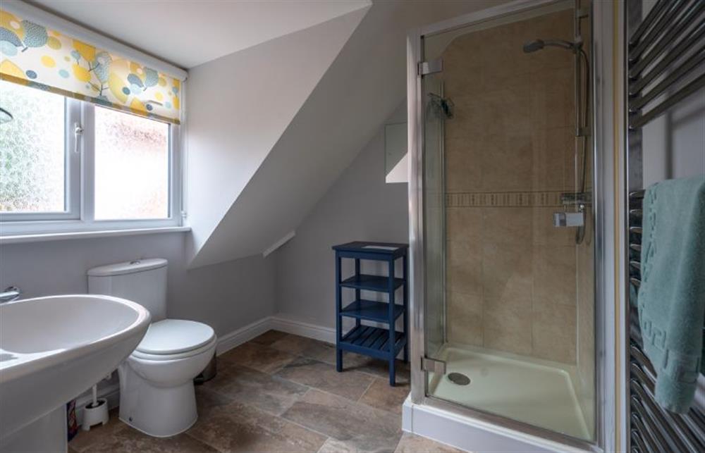 En-suite with a shower, wash basin and WC