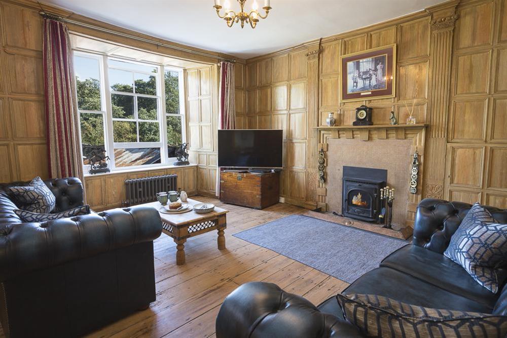 Cosy sitting room with restored oak panelling and Chesterfield sofas at South Wing in , Nr Kingsbridge