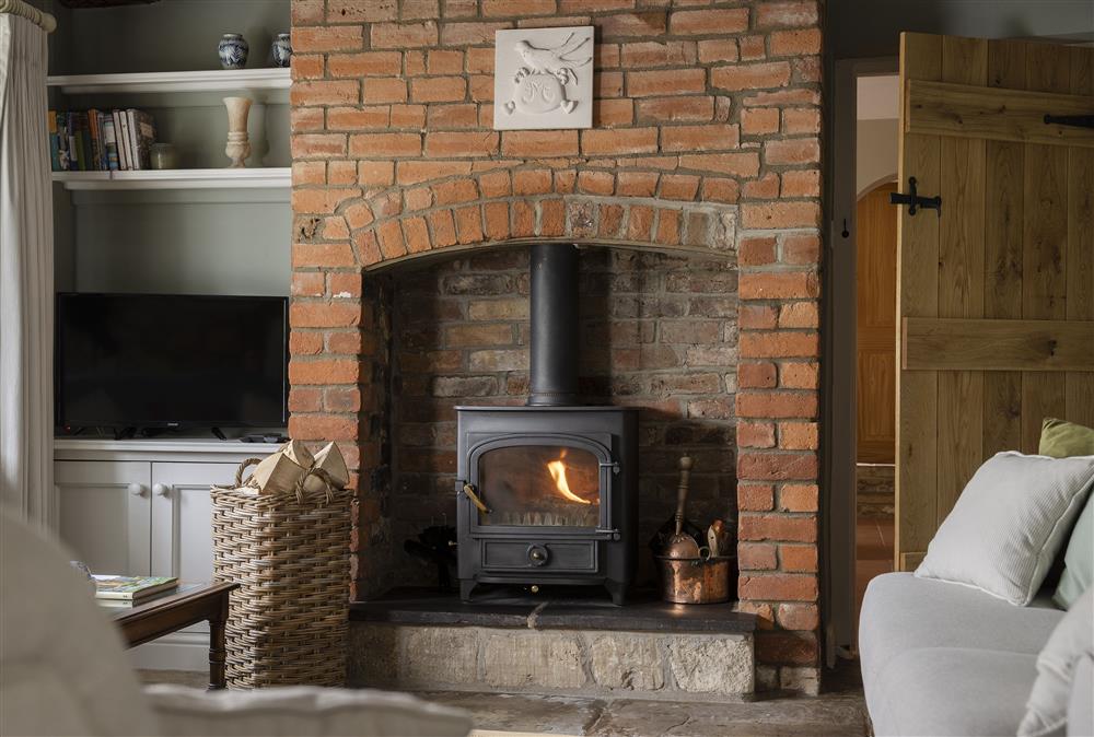 Cosy up in front of the cosy wood burning stove with a cup of cocoa  at Southcroft Cottage, Bredons Norton