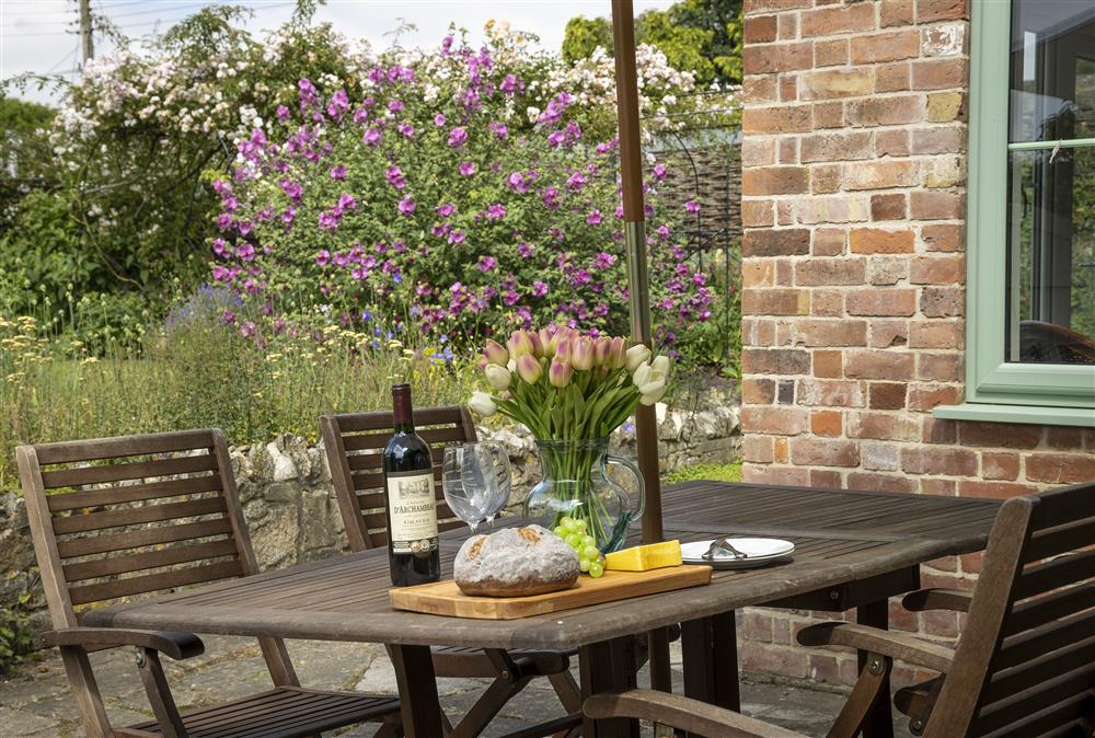Enjoy dining outside in the pretty garden at Southcroft Cottage at Southcroft Cottage, Bredons Norton
