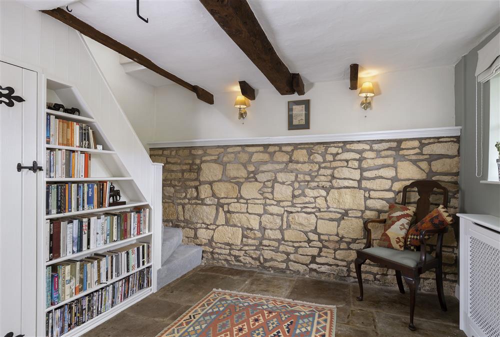 Ground floor: Reading area in the sitting room with stairs leading to first floor bedrooms at Southcroft Cottage, Bredons Norton