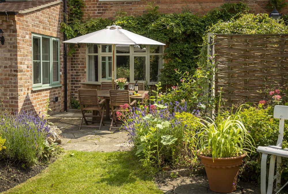 Relax and unwind in the pretty garden terrace  at Southcroft Cottage, Bredons Norton