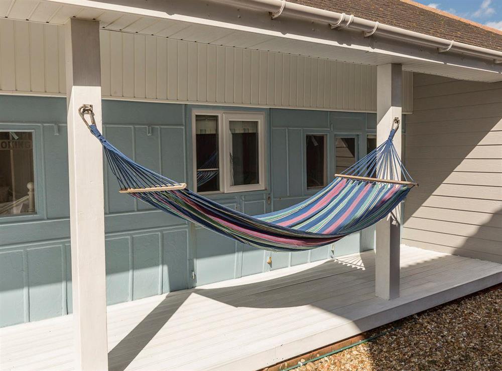 Relaxing hammock in decked patio area at Southern Bell in Hayling Island, Hampshire