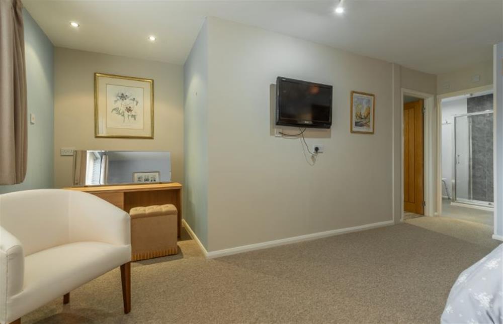 First floor: Bedroom showing seating area and dressing table at Southview Annexe, Sculthorpe near Fakenham