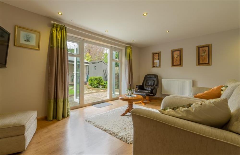 Ground floor: Sitting room area with doors to sunny garden at Southview Annexe, Sculthorpe near Fakenham