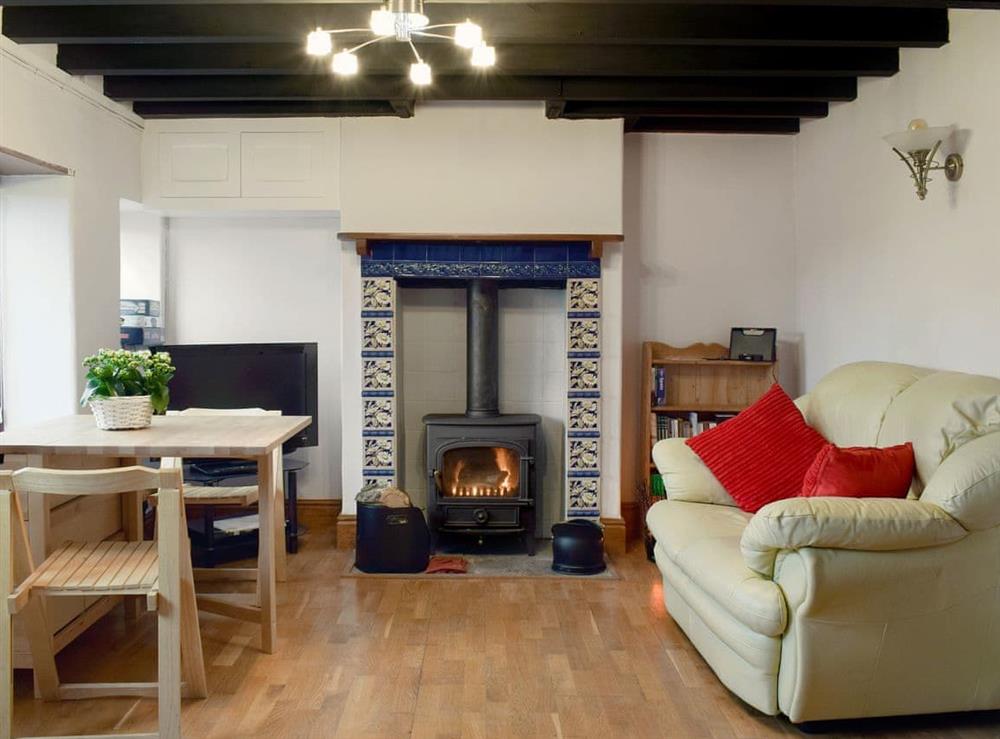 Cosy living/ dining room with wood burner at Southview in Porchfield, near Newport, Isle of Wight