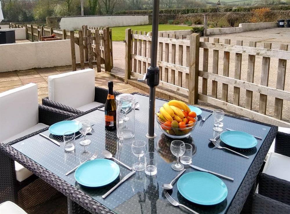 Enclosed patio area with outdoor furniture at Sparrow in Shipton Gorge, Dorset