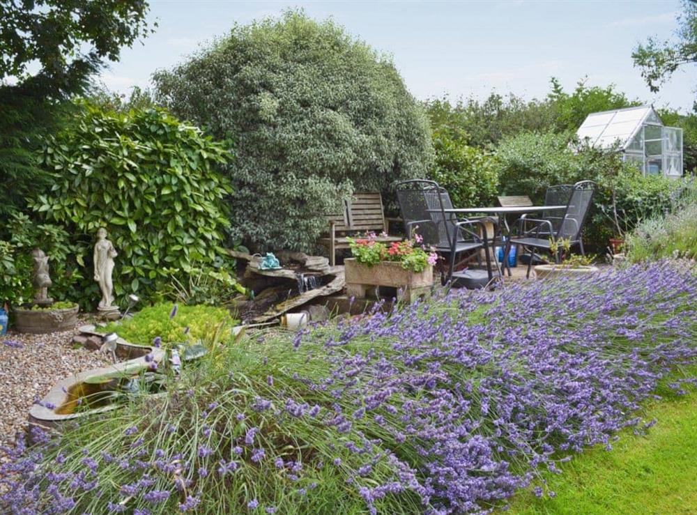 Shared, enclosed, lawned garden with sitting-out area and furniture at Sparrows Nest in Wrangway, near Wellington, Somerset