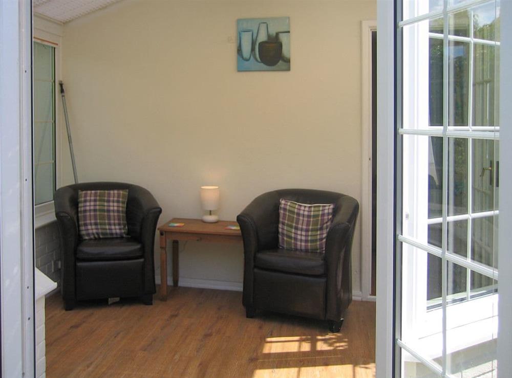 Light and airy seating area within the conservatory at Speedwell Cottage in Trunch, near North Walsham, Norfolk