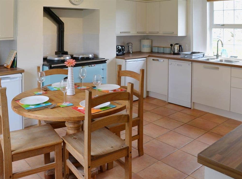 The Aga can make the kitchen dining room a cosy and warm place to enjoy meaks at Speedwell Cottage in Trunch, near North Walsham, Norfolk