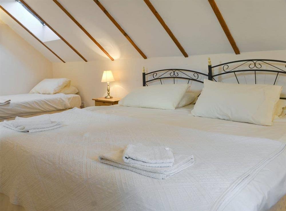 En-suite family bedroom with a double and a single bed at Speke’s Retreat in Hartland, Devon