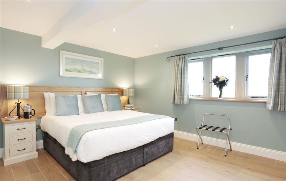 First floor: Double bedroom with zip and link bed with en suite and views onto front lawn, fields and reservoir