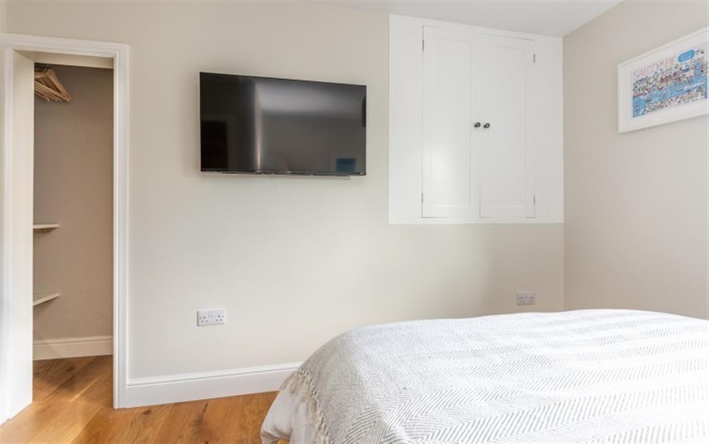 Bedroom 1 has a small walk in wardrobe and wall mounted smart TV at Spindleberry in South Pool