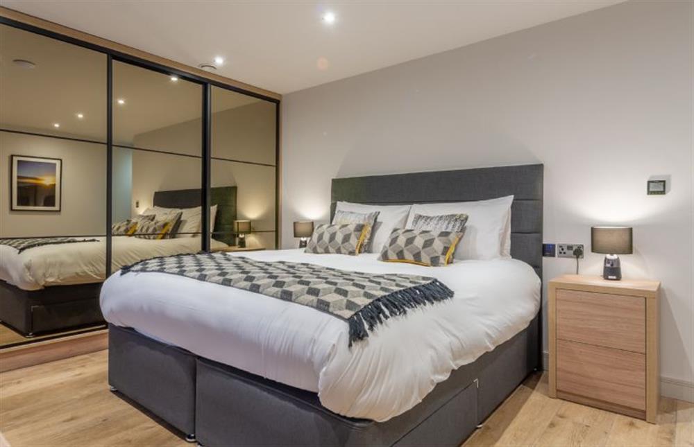 Bedroom five with 6’ super- king size bed and en-suite shower room at Spindrift, Old Hunstanton