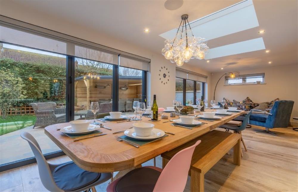 Dining area  seating for 14 guests and bi-fold doors opening on the outdoor entertaining area at Spindrift, Old Hunstanton