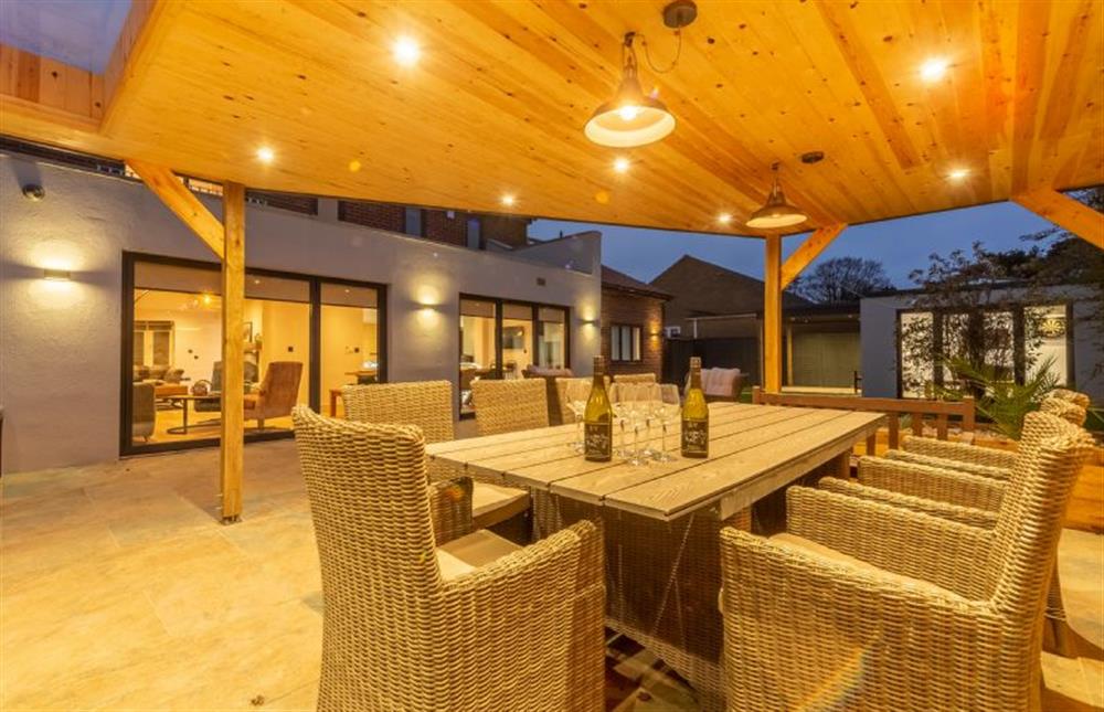 The heated, outdoor kitchen and dining area set under an illuminated canopy (photo 2) at Spindrift, Old Hunstanton