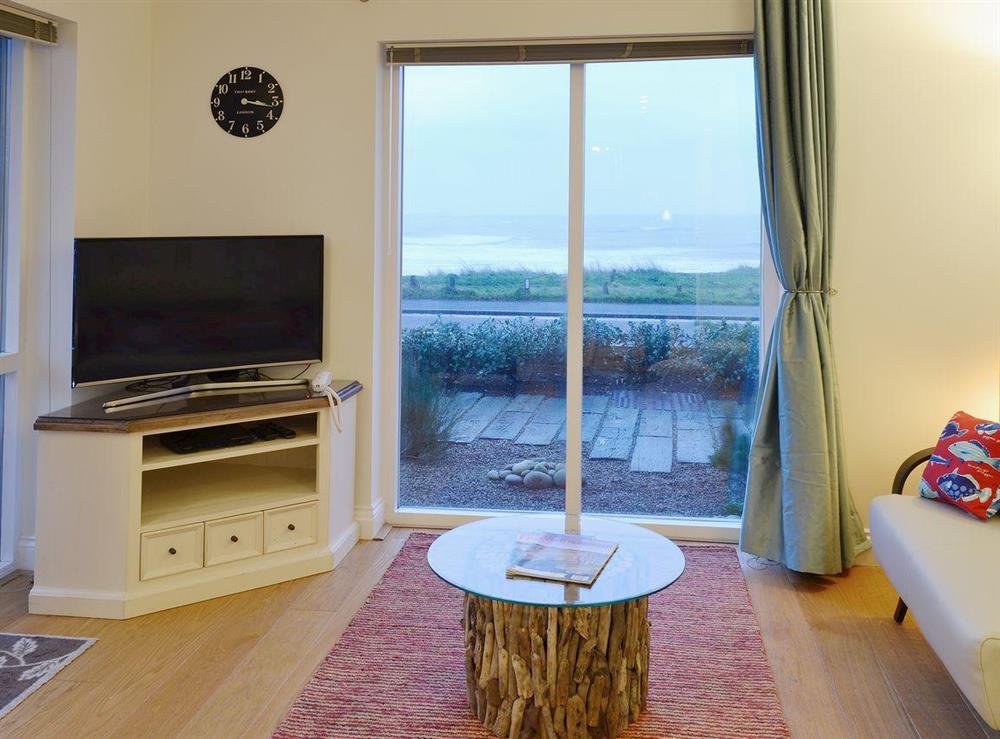 In addition to the comfortbale seating,  a curved-screen smart tv is available for guests’ use at Spindrift in Seahouses, Northumberland